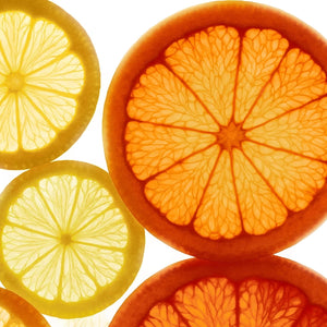 Close-up of sliced citrus fruits including oranges, lemons, and grapefruits, arranged in a circular composition