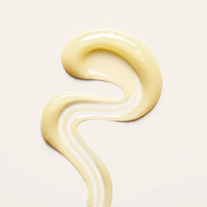 Leave-In Cream Conditioner swatch with a smooth, curled texture on a beige background