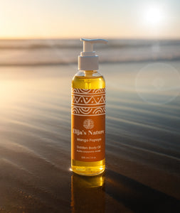Golden Body Oil – #scent_Mango Papaya #size_8oz - Bottle of Elija’s Nature Mango Papaya Golden Body Oil 8oz standing upright on wet sand at the beach during golden hour