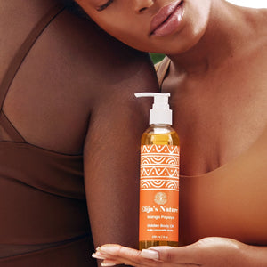 Golden Body Oil - #scent_Mango Papaya #size_8oz – A serene woman leans against her friend while holding a bottle of Golden Beauty Oil in Mango Papaya